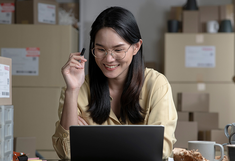 Smiling Asian woman ordering samples from Associated Bag Company